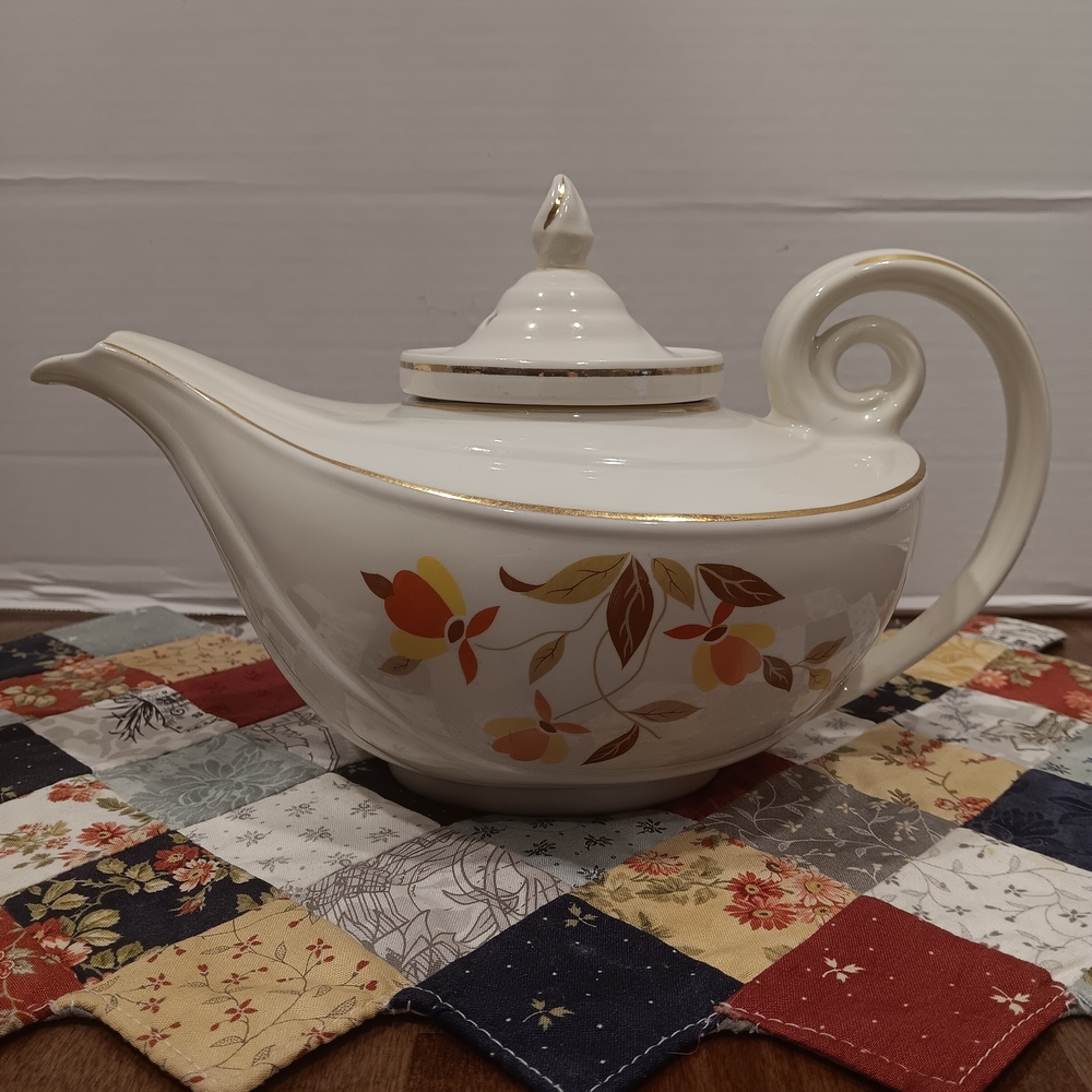 Elegant White Ceramic Teapot with Floral Accent and Gold Trim